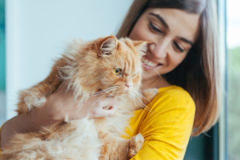 Woman holding cat in arms