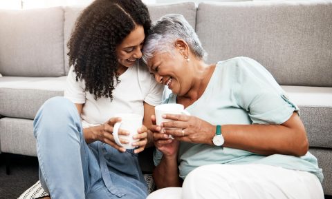 Two Family Members Drinking From Mugs