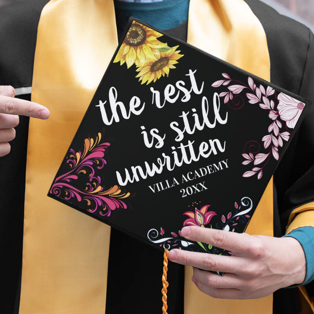 Man pointing at graduation cap topper.