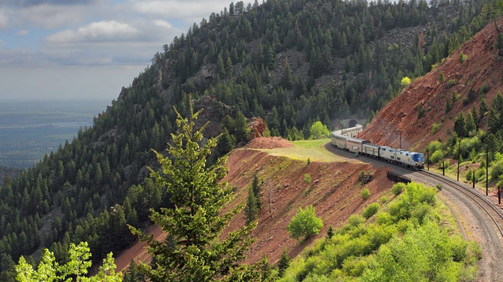 The Amtrak California Zephyr train traveling along a scenic mountain route.