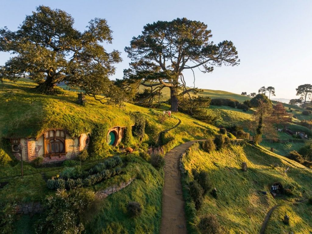 The iconic Hobbiton Movie Set located in New Zealand's Waikato region, which includes the famous Hobbit Holes and the Green Dragon Inn.